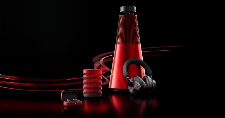 Ferrari x Bang & Olufsen collection including Beoplay H95, Beosound 2, Beosound Explore, and Beoplay EX in Rosso Corsa red on black background
