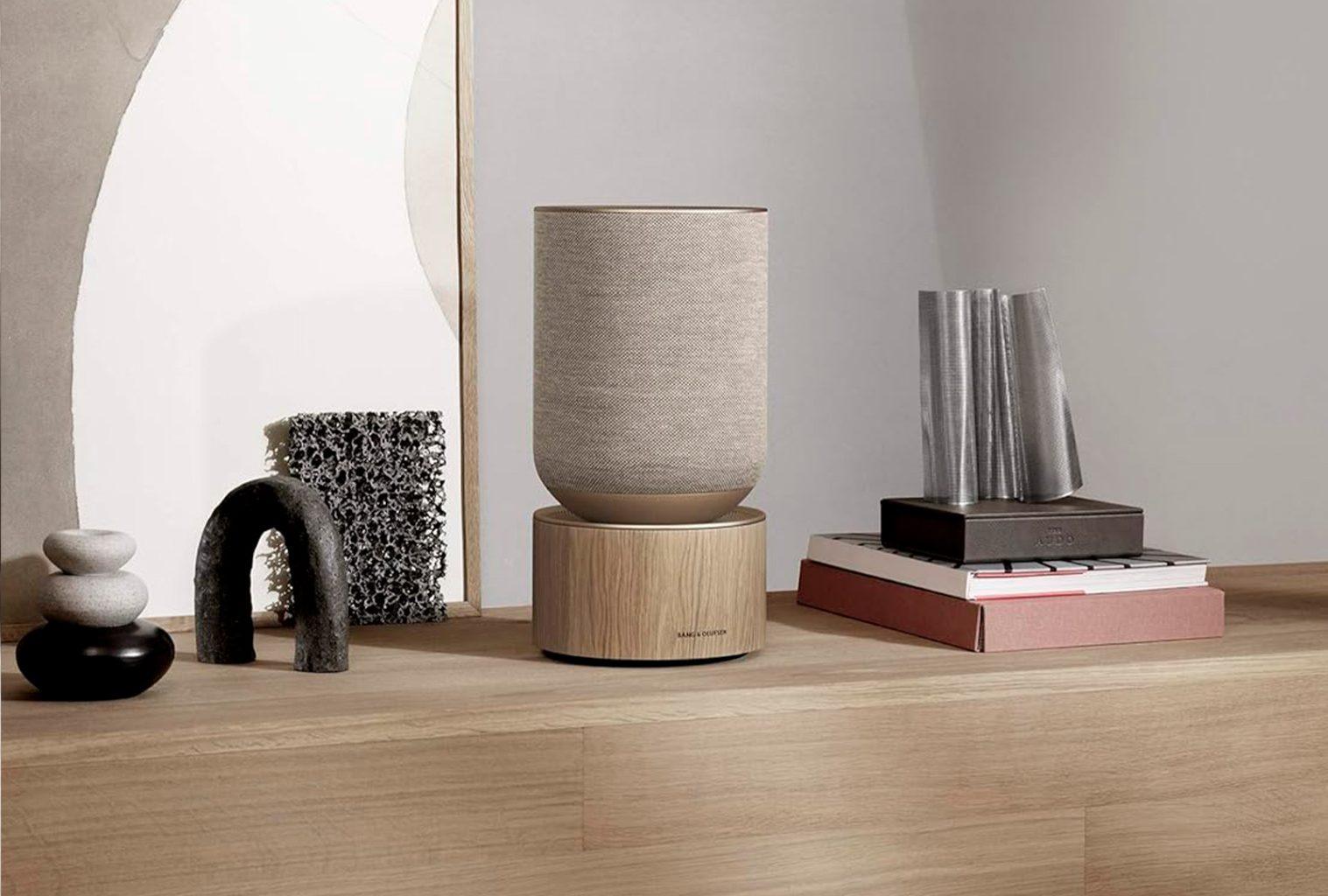 Bang & Olufsen Beosound Balance speaker in Natural Oak, styled on a wooden shelf with modern decor elements and sculptural objects