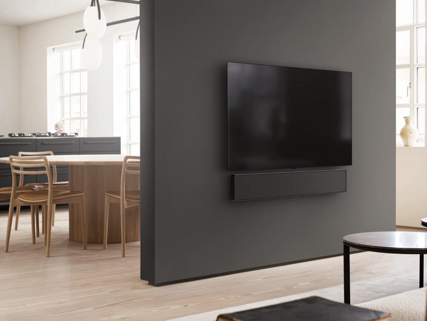 Bang & Olufsen Beosound Balance speaker in Natural Oak, styled on a wooden shelf with modern decor elements and sculptural objects