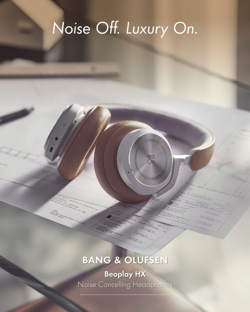 Bang & Olufsen Beoplay HX noise cancelling headphones resting on architectural drawings, with soft sunlight and the headline “Noise Off. Luxury On.” – highlighting premium sound and minimalist design.